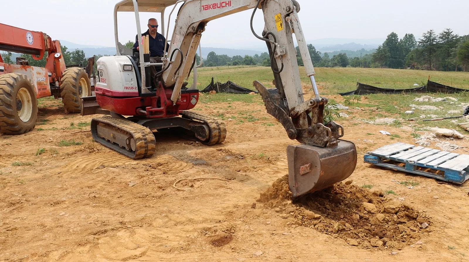 Excavator working at a soil investigation site