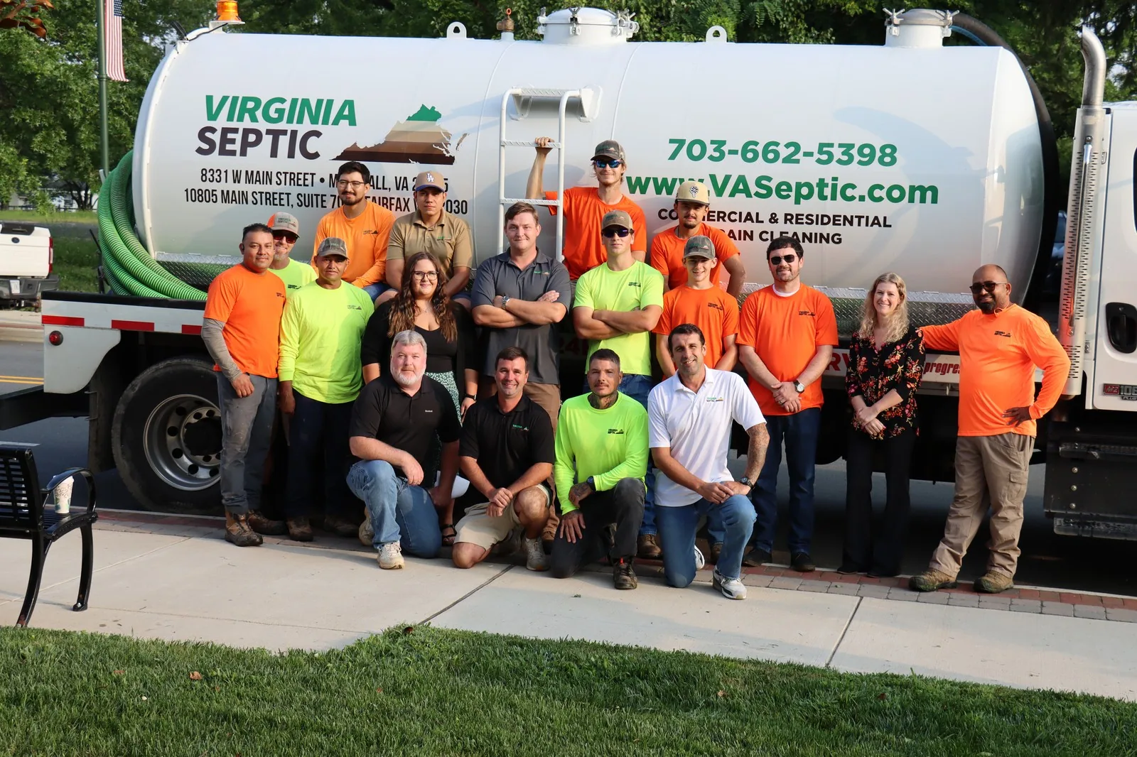 Virginia Septic crew standing with a service truck